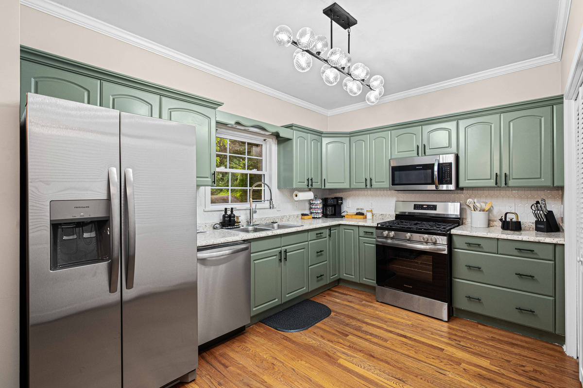 Kitchen Oasis: Whip up culinary delights in this stylish green-accented kitchen with modern appliances!