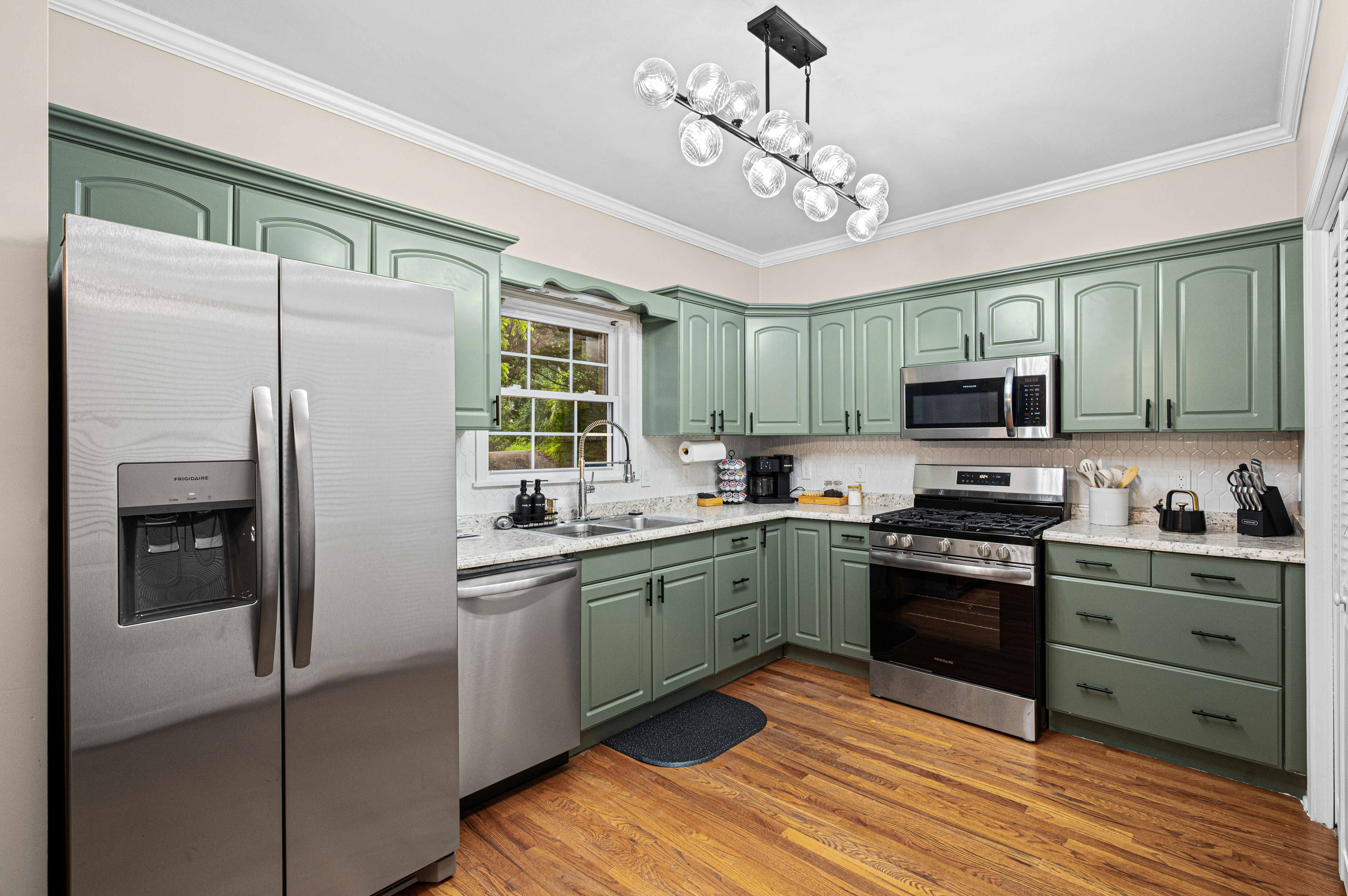 Kitchen Oasis: Whip up culinary delights in this stylish green-accented kitchen with modern appliances!
