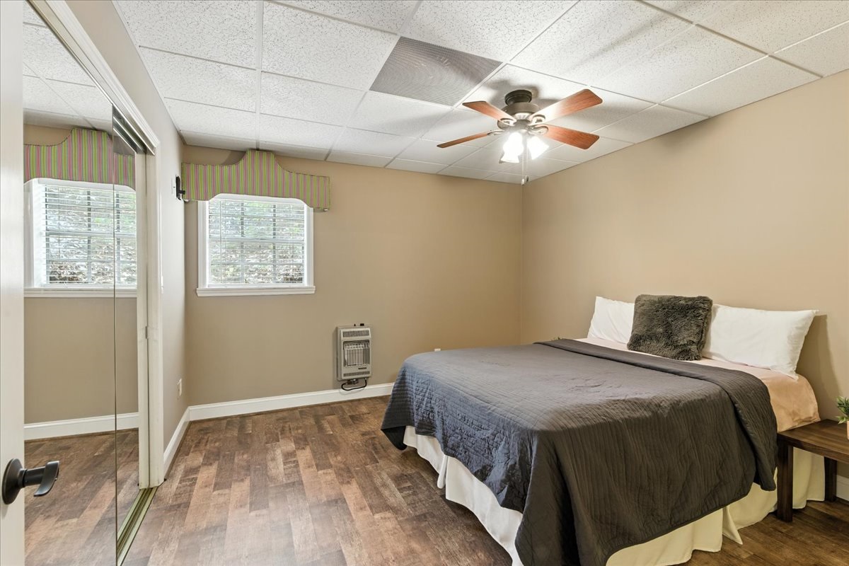 A bedroom with a queen bed and in-suite bathroom located in the basement.