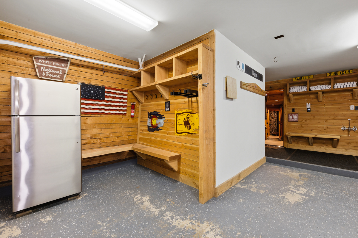 Ski and outdoor adventure vibes are carried through to the heated one-car garage with room for gear storage, seating for boot removal, and a refrigerator for additional cold-food storage. 