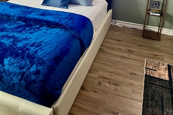 Queen bed with floor space nearby and an easy layout for moving around the studio.
