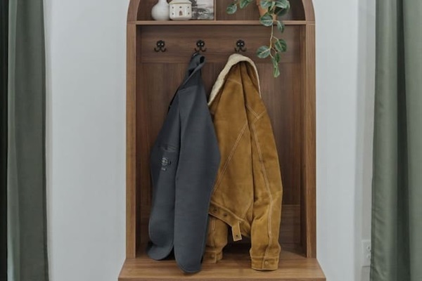 Charming entry nook with a built-in bench and coat hooks, giving guests a convenient spot to store jackets, bags, and shoes.