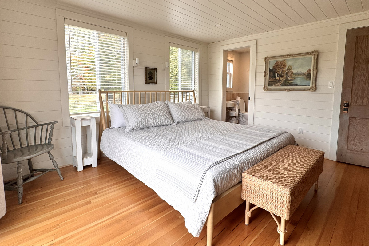 Spacious main floor primary bedroom with ensuite bath and views.