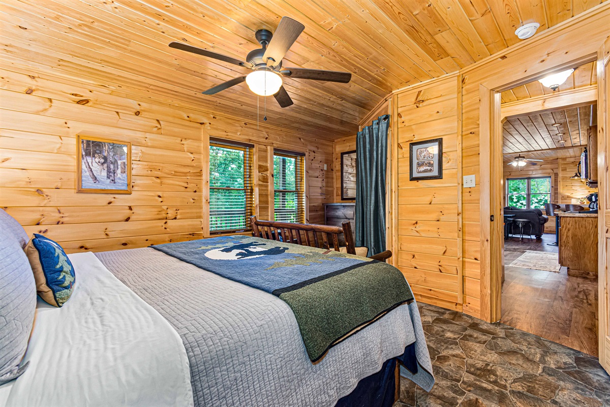 Enjoy the beauty of natural wood and a tranquil setting in this inviting bedroom.