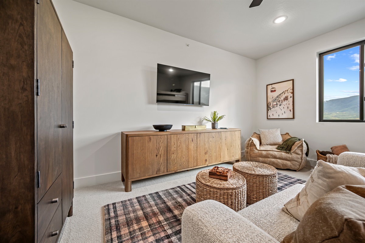 Relax with a movie or board game in this inviting space featuring plush seating, a flat-screen TV, and warm mountain-inspired décor.