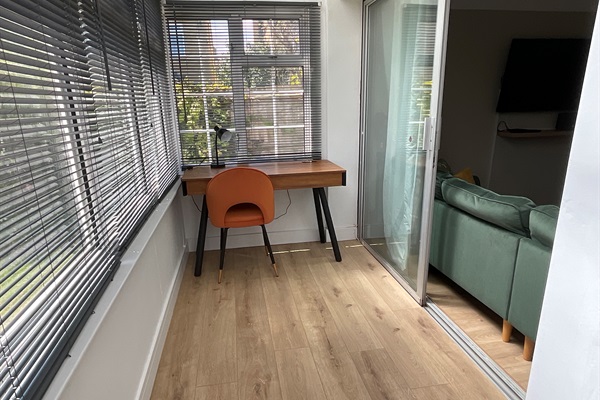 The porch area has a smart desk that with Bluetooth speakers to cast music to.  Alternatively, there is room here to store bicycles.
