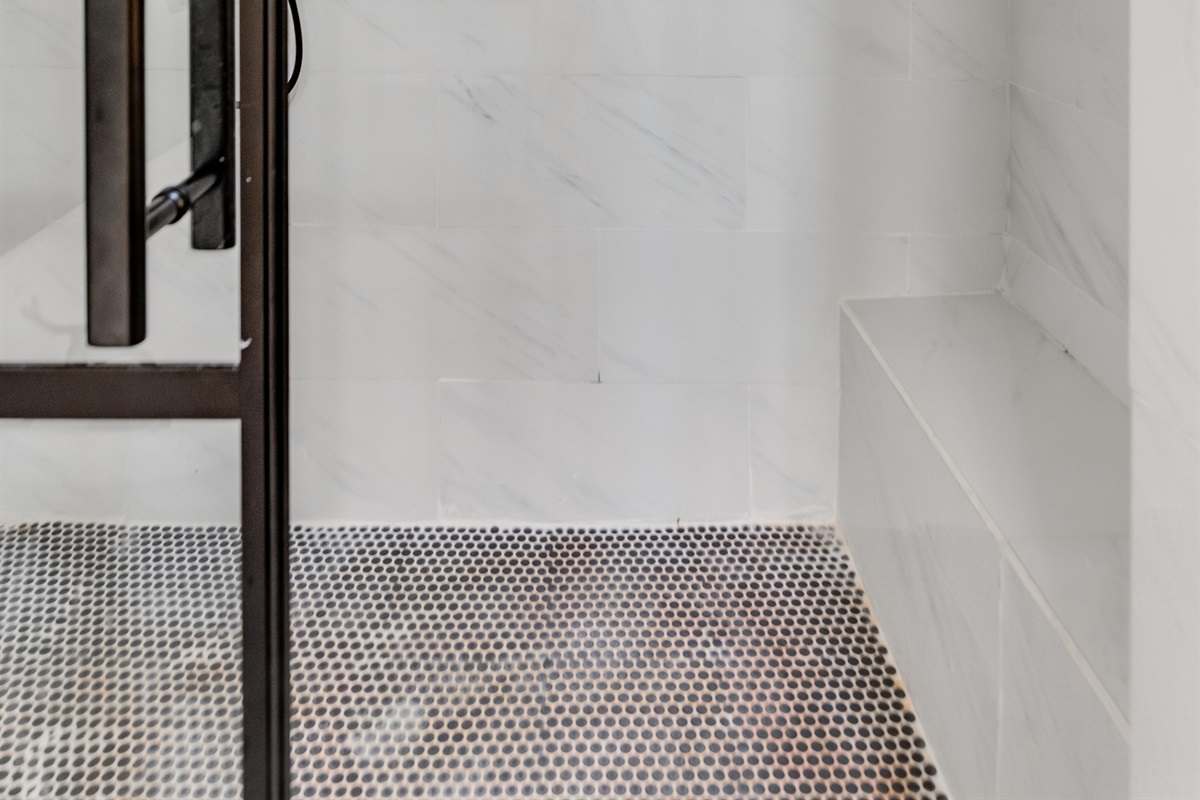 Upstairs Ensuite Full Bathroom 2: Experience luxury with a spacious walk-in shower and elegant marble tiles!