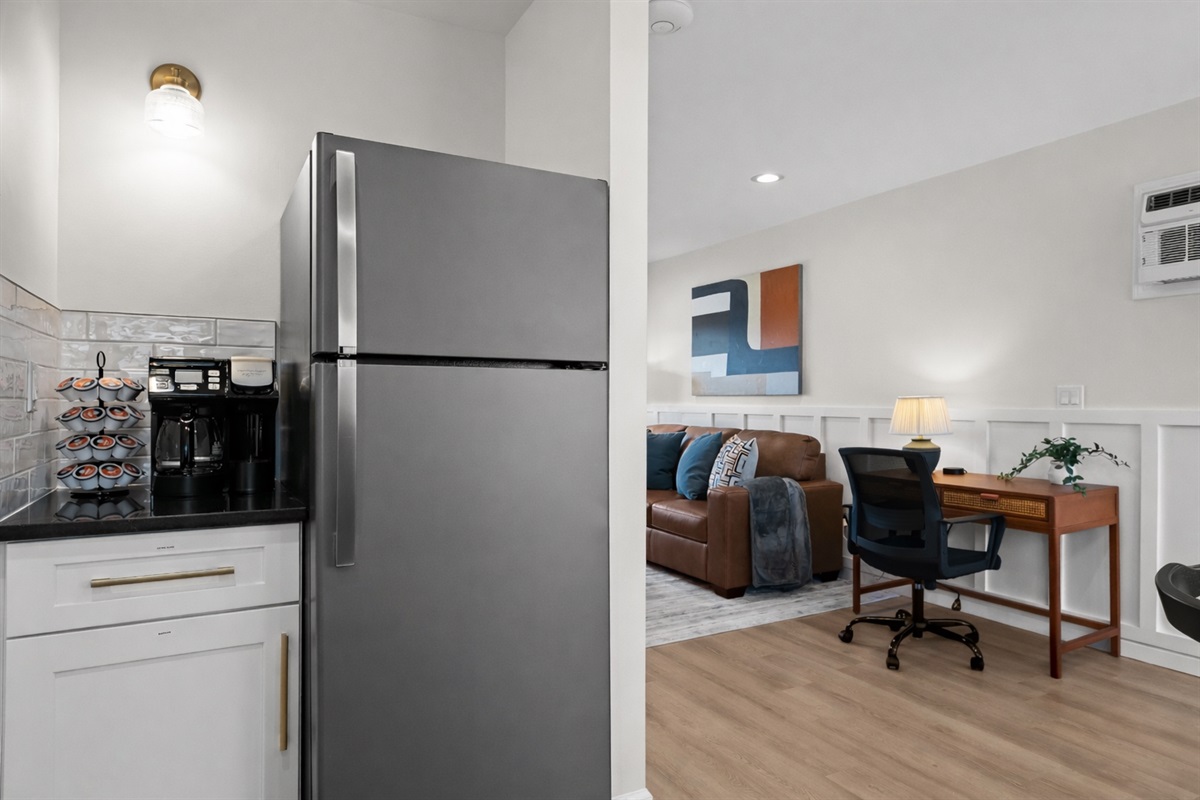 Thoughtfully designed open space with modern kitchen, cozy living area, and dedicated workspace—perfect for work, relaxation, and extended stays.