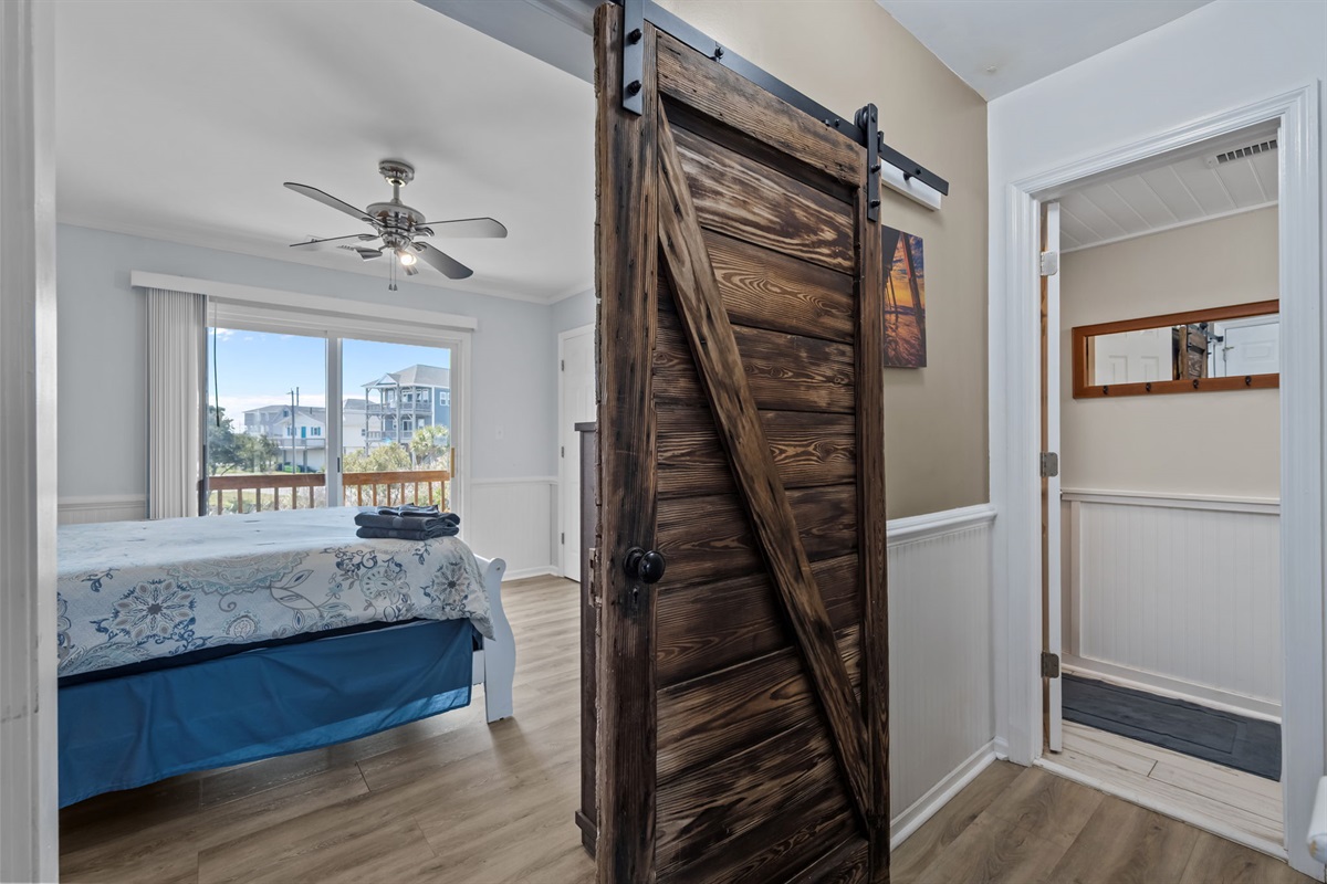 Main floor bedroom with sliding barn door entrance