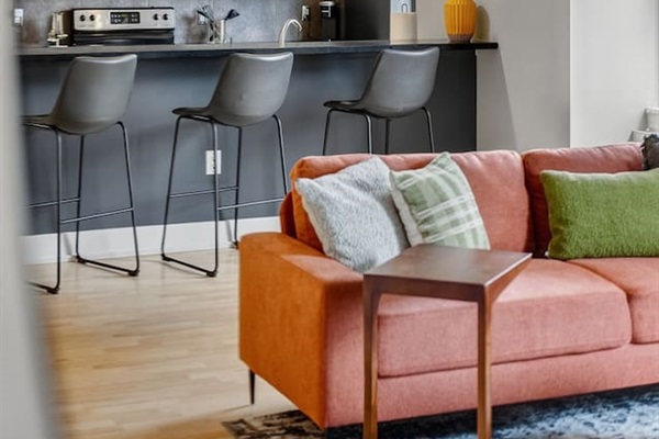 Gather around the stylish breakfast bar with seating for three. Perfect for morning coffee, casual meals, or evening cocktails, all while overlooking the bright, modern living space.