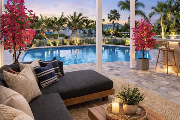 Private waterfront backyard with heated pool, outdoor lounge and tropical landscaping