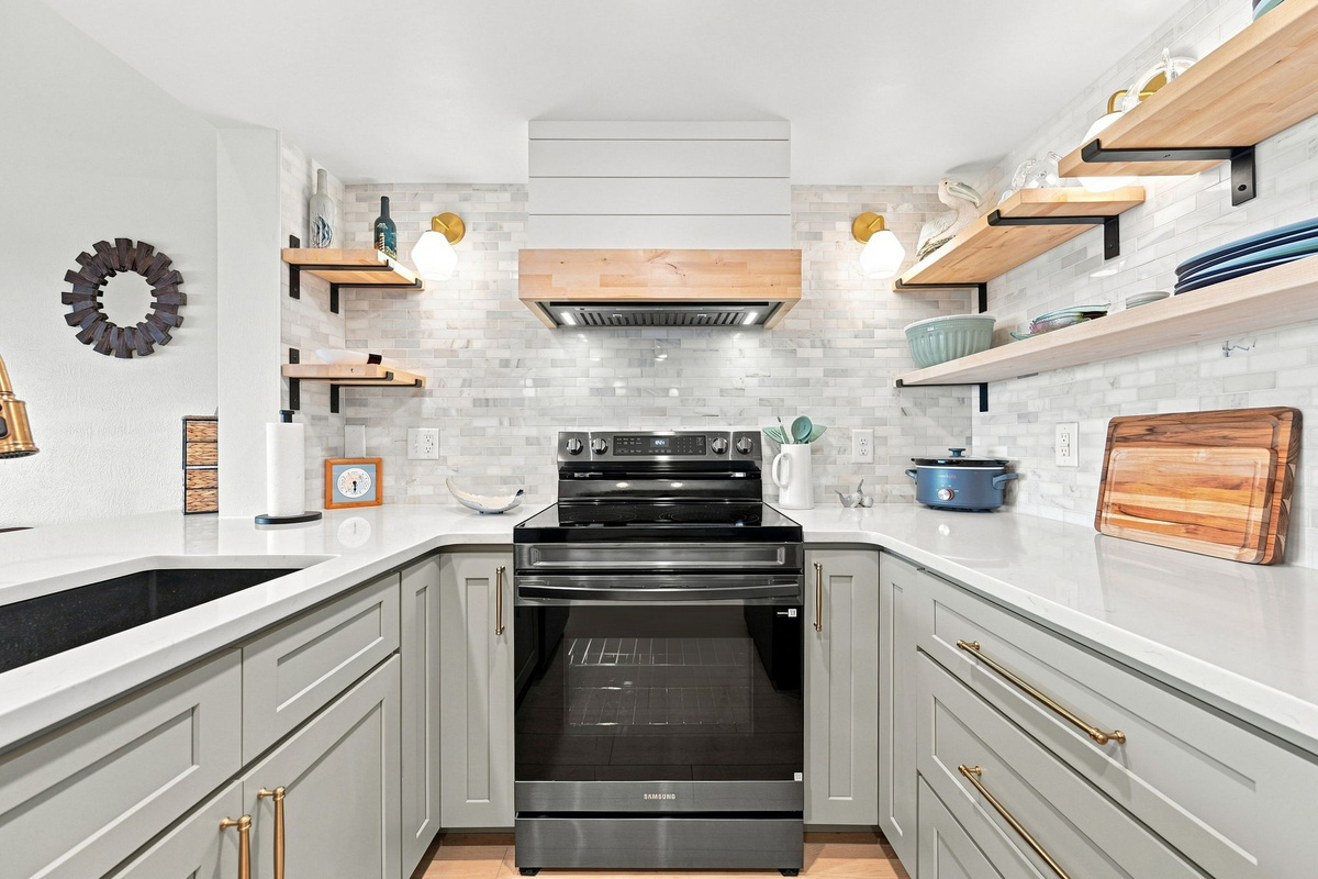 Sleek updated fixtures, crisp white countertops, and a crockpot ready for those effortless vacation dinners.

