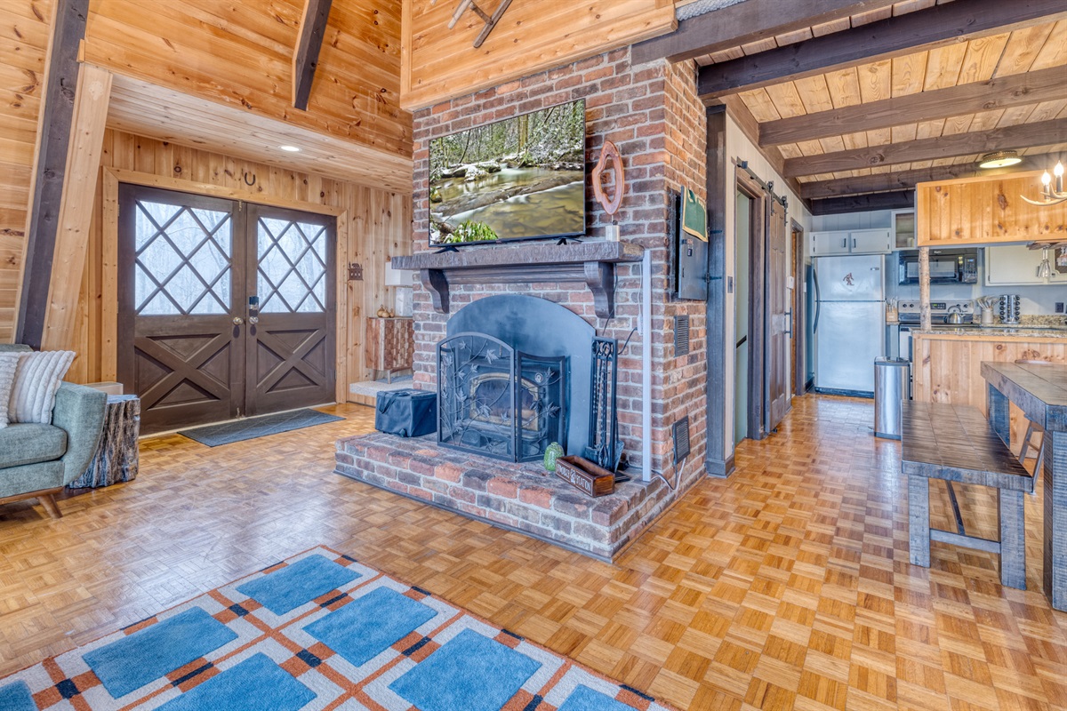 Double doors offer a grand entrance, connecting the living room to the kitchen and dining area, perfect for socializing and family gatherings.