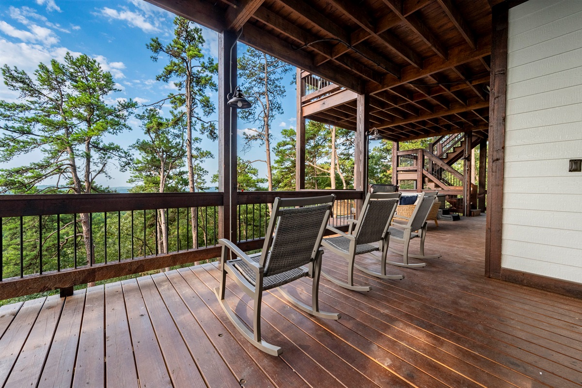 Spacious wraparound deck with relaxing seating surrounded by nature