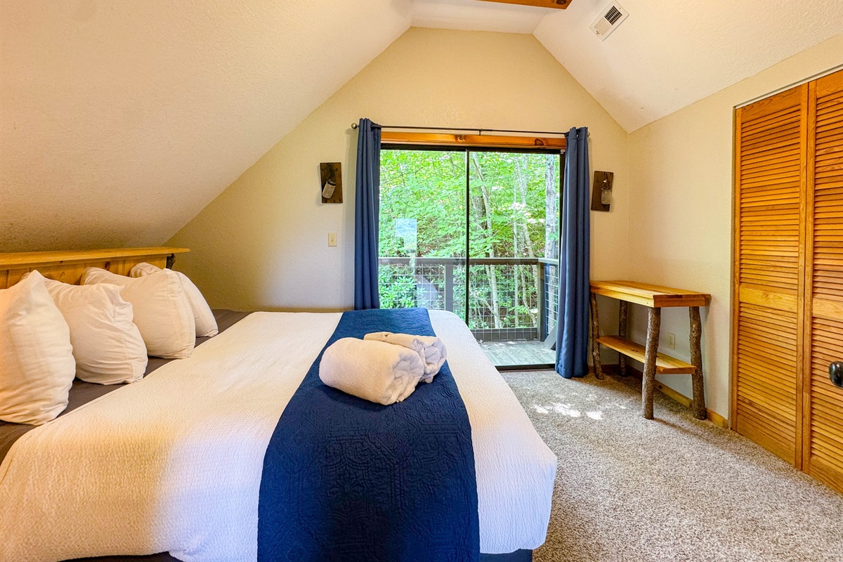 the back upper level bedroom features a hybrid memory foam bed and shredded bamboo pillows. There is a private Juliet balcony as well. This room also has a crib in the closet:)