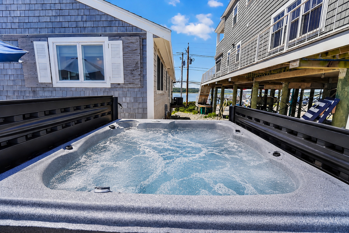 Unwind in the bubbling hot tub after a full day of beachside fun.