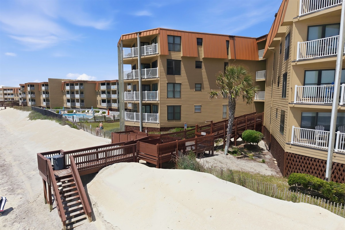 Direct beach access walkway leading from the community straight to the sandy shoreline
