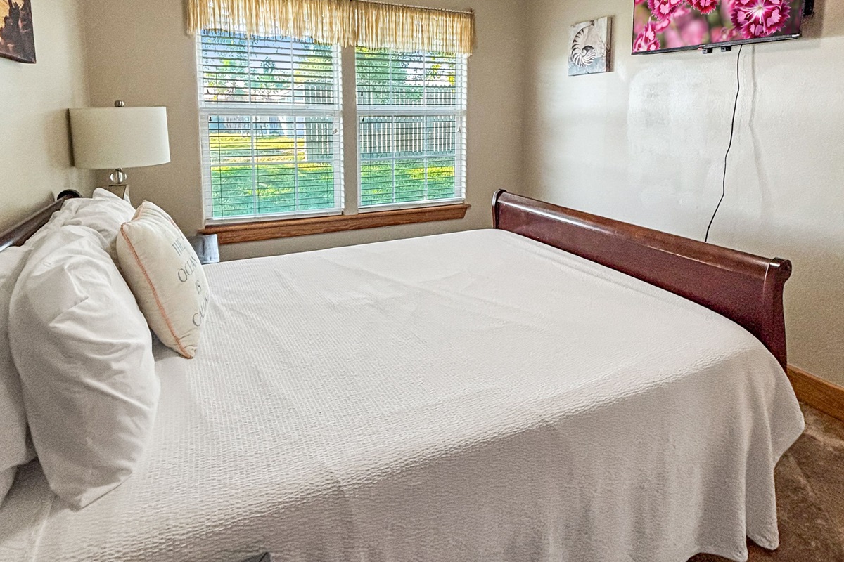 Bedroom 2 offers a queen and flat screen