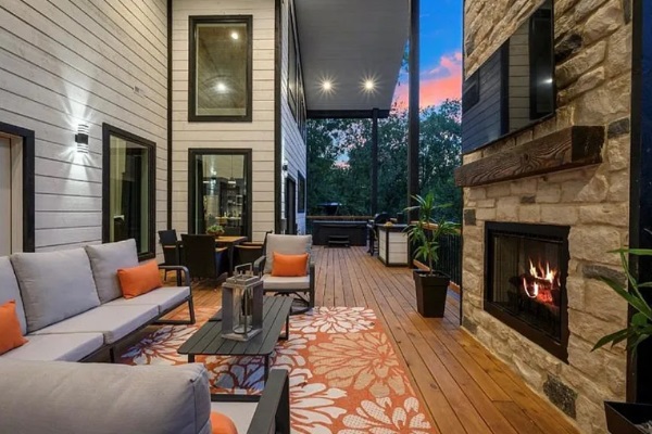 Covered outdoor lounge with fireplace