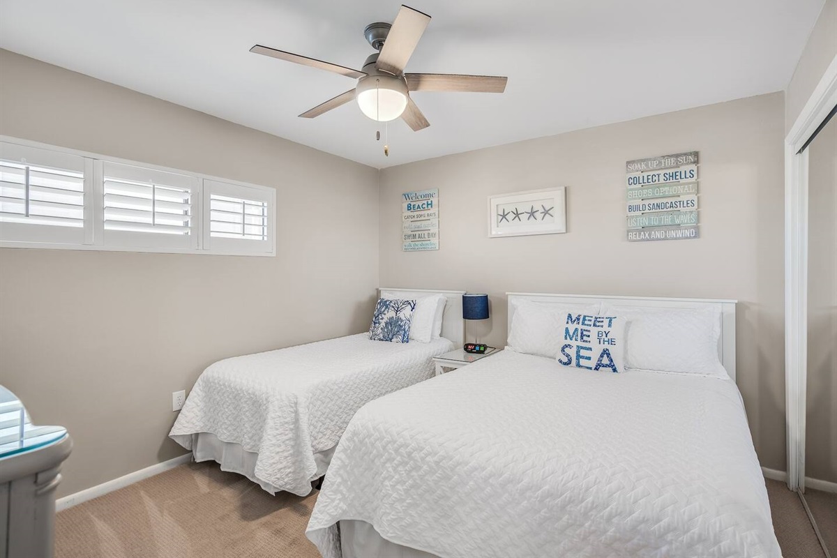 The secondary bedroom is spacious with a Queen and twin bed + private bathroom