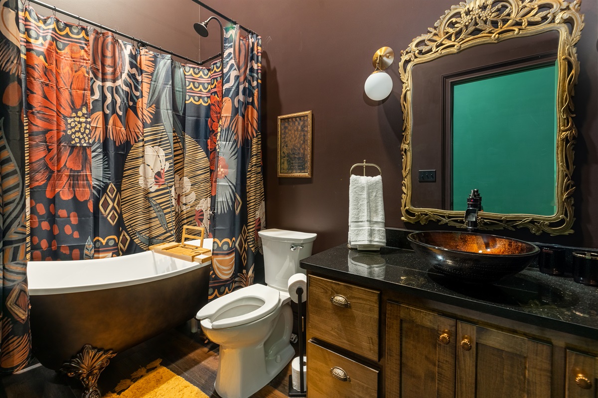 Clawfoot bathtub with shower head. 