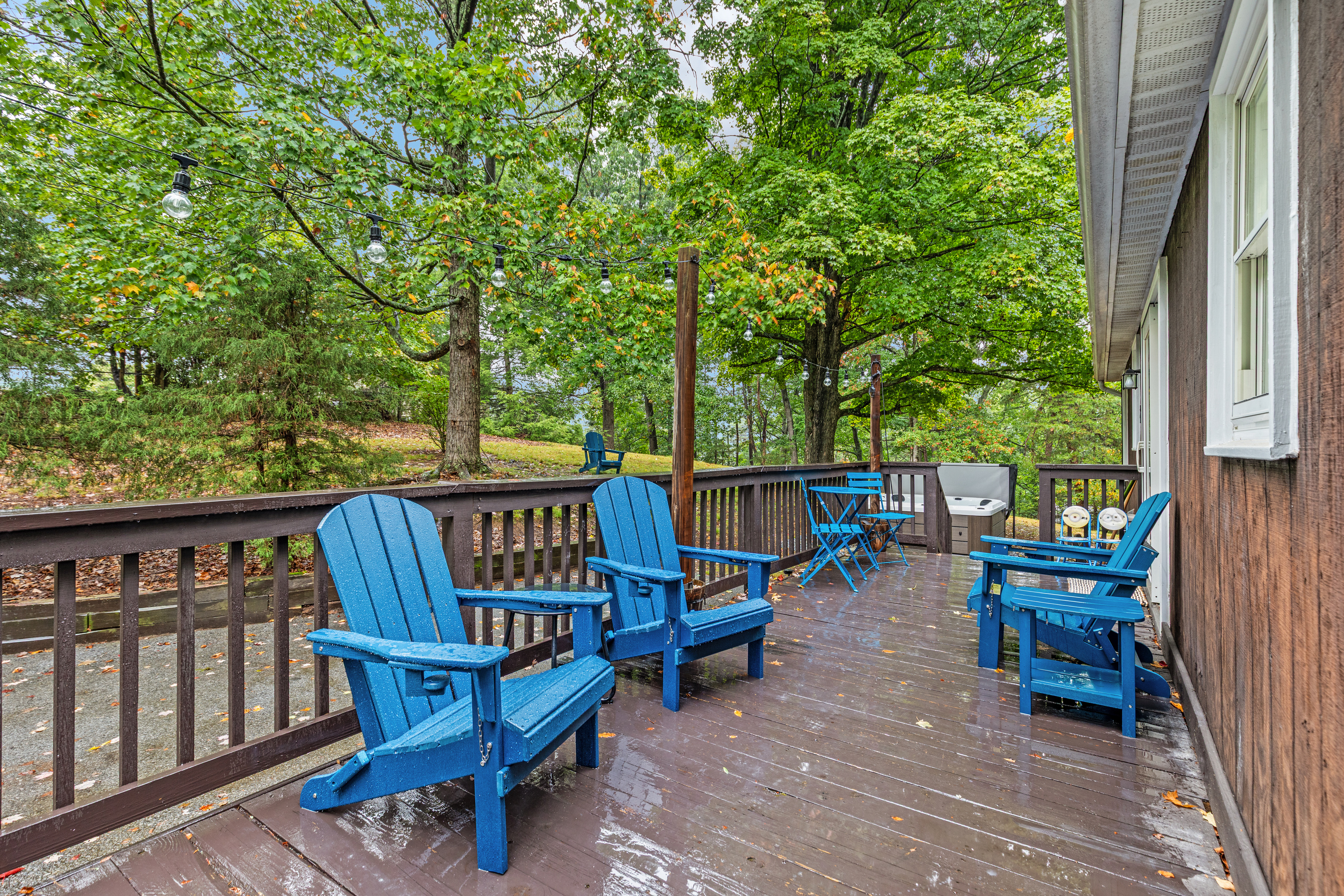 Pull up an Adirondack chair on the deck and soak in the sounds of the surrounding trees — with string lights overhead and a grill on hand for firing up dinner, it's the perfect spot to unwind, relax, and enjoy the outdoors.