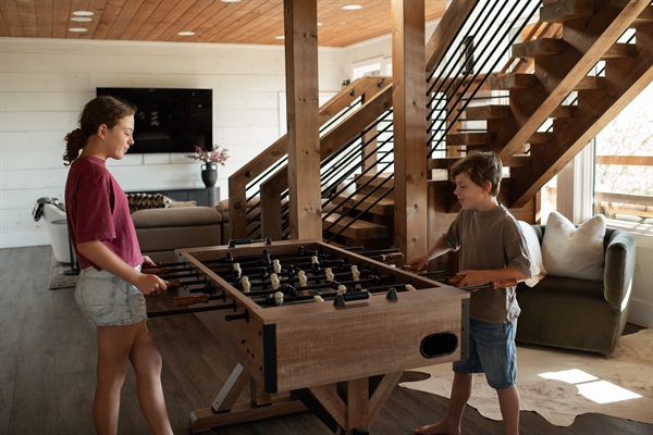Game Lounge | Elevated entertainment space with foosball and cozy reading nook