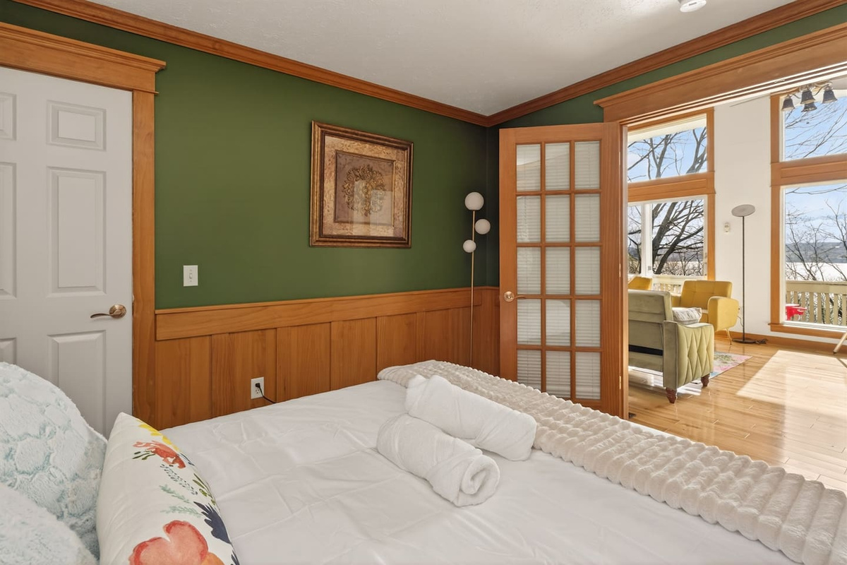 “Escape to the Olive Bedroom—a cozy, nature-inspired retreat with calming green tones and warm wood finishes. Enjoy restful sleep, natural light, and easy access to the living space for a seamless, relaxing stay.”