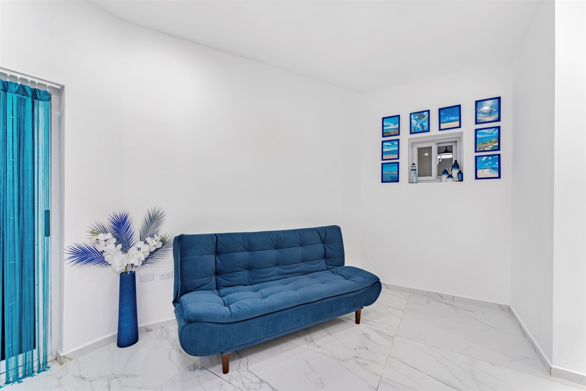 Blue futon folds down for additional sleeping