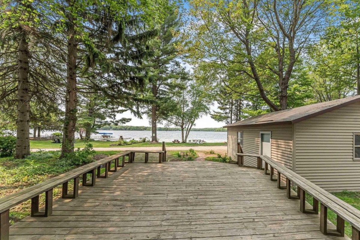 Hang out on the spacious deck to enjoy private slice of Lake Ann – 100 ft of flat, sandy frontage.