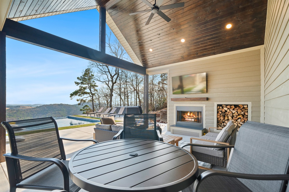 Relax under the covered patio with comfortable seating and a fireplace that makes cool evenings feel extra cozy.