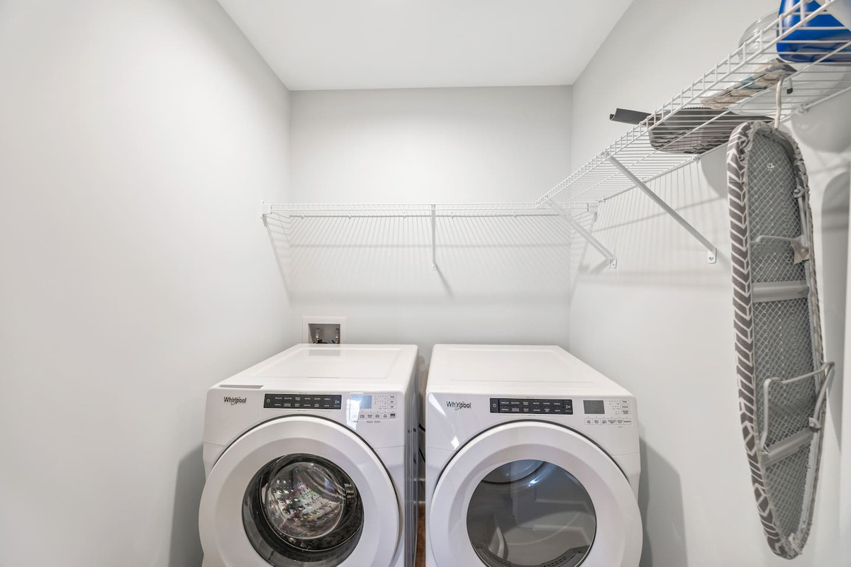 Equipped with a Whirlpool washer and dryer, plus shelving and an ironing board — everything you need to keep things fresh during your stay.