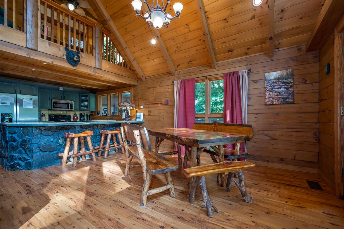 Large hand crafted log dining table , can sit up to 10, with three bar seats at kitchen island. We also have a large picnic table on the covered deck right outside of the dining table.