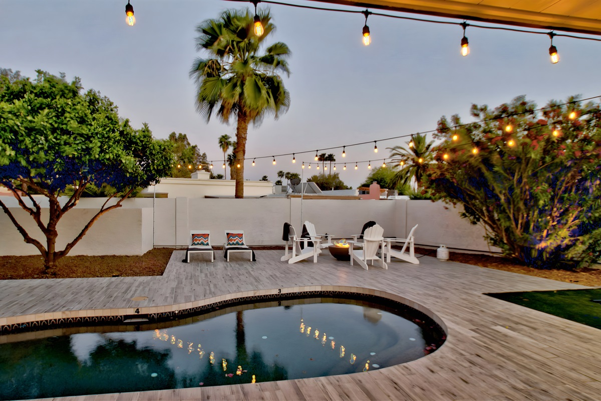 View from the covered patio | Lights around the pool, sun deck, and fire pit
