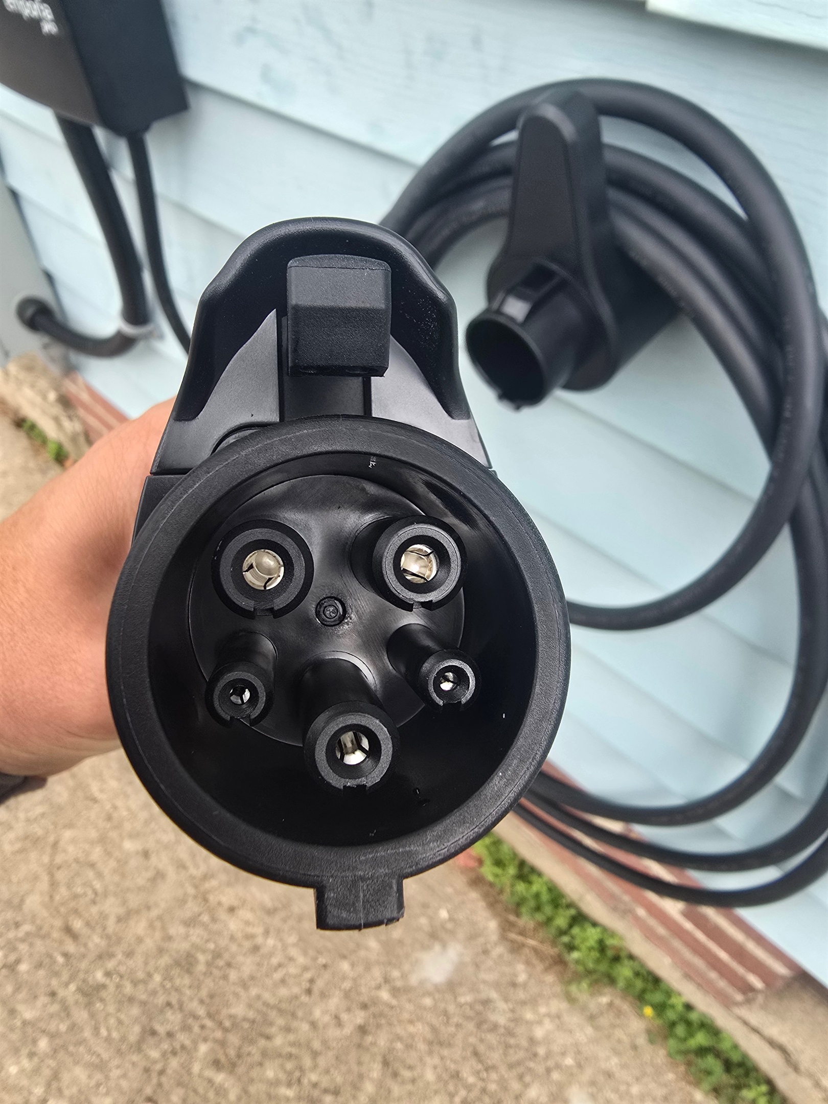 Close-up of our NEMA 14-50 setup—this heavy-duty attachment hose connects securely for Level 2 EV charging, delivering reliable power right from the side entrance. Just plug in, charge up, and hit the road.