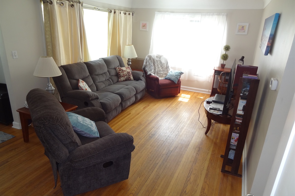 Living room with couch, recliners, and Roku smart TV