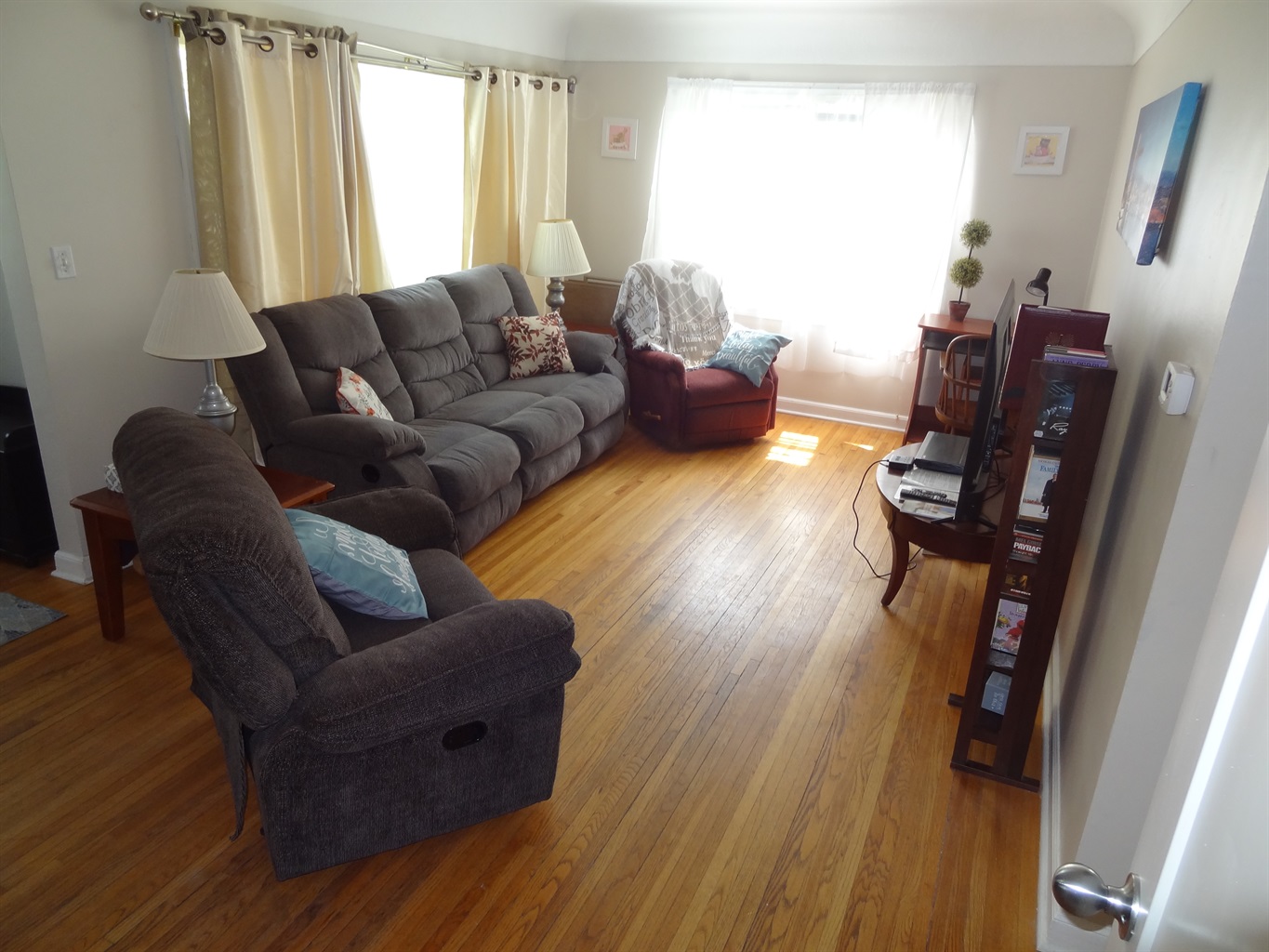 Living room with couch, recliners, and Roku smart TV