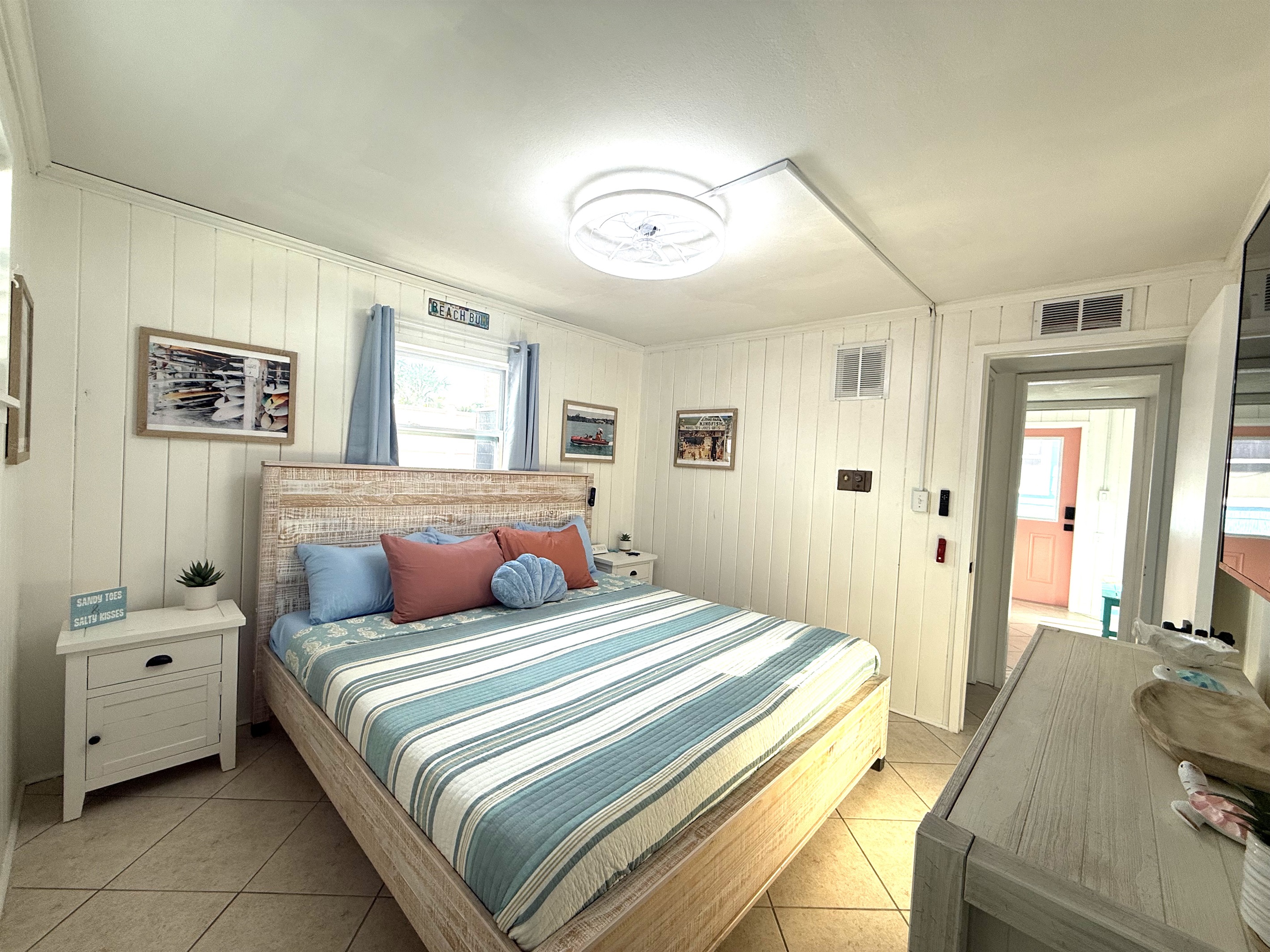 Primary Bedroom Alternate View with King Bed & Retro Photos & 65" TV