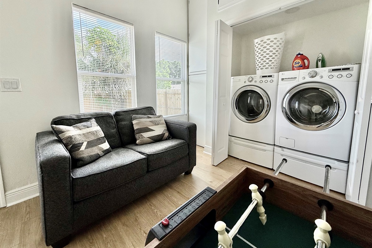 Who says chores can’t be fun? This space combines practical amenities like a washer and dryer with a full-size foosball table—perfect for multitasking or blowing off steam.