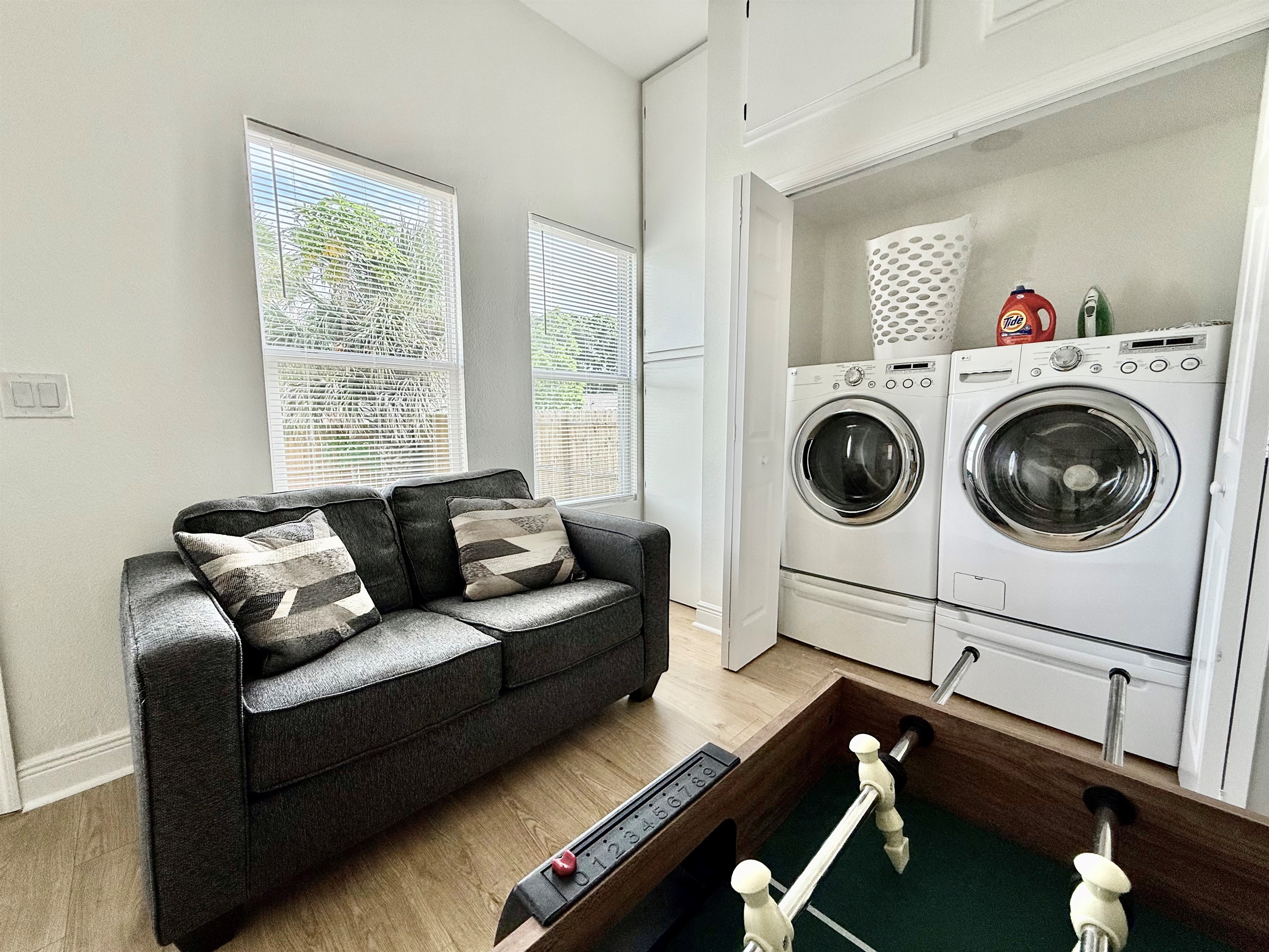 Who says chores can’t be fun? This space combines practical amenities like a washer and dryer with a full-size foosball table—perfect for multitasking or blowing off steam.