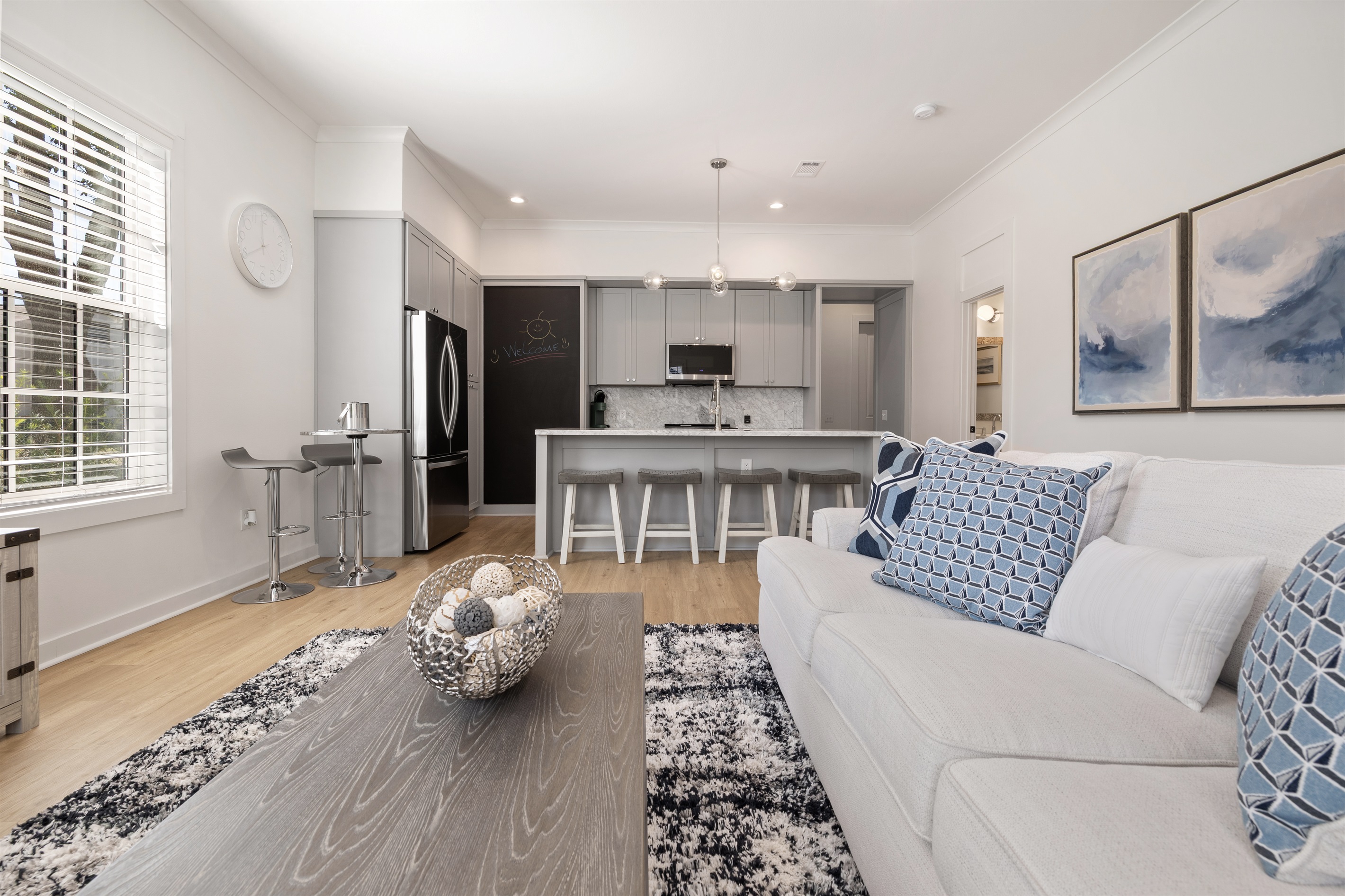 Bright and airy living room with coastal-inspired design and plush seating for the whole family.