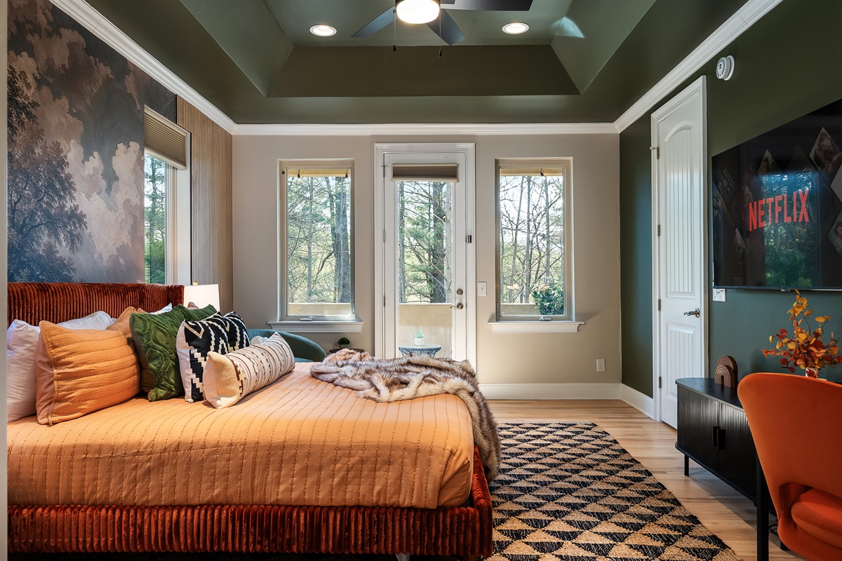 Large bedroom with multiple windows and seating - plenty of space to spread out and relax