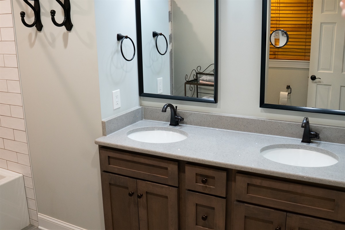 The bathroom features a double sink with spacious countertops and large mirrors for added convenience.
