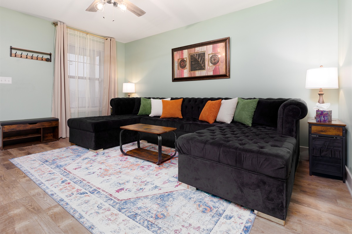 Inviting living room designed for gathering, relaxing, or enjoying a movie night. Comfortable seating and an open layout make it easy for everyone to spend time together.