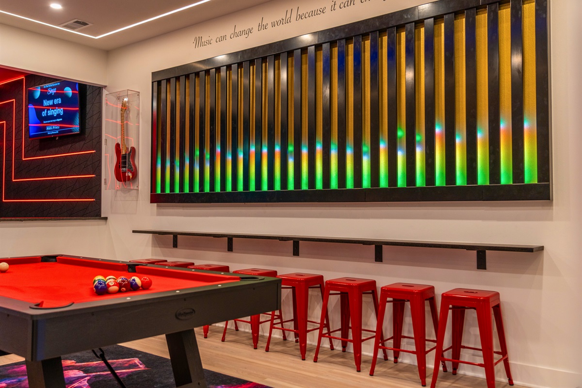 Neon lights and vibrant decor create a lively atmosphere for game nights with friends.