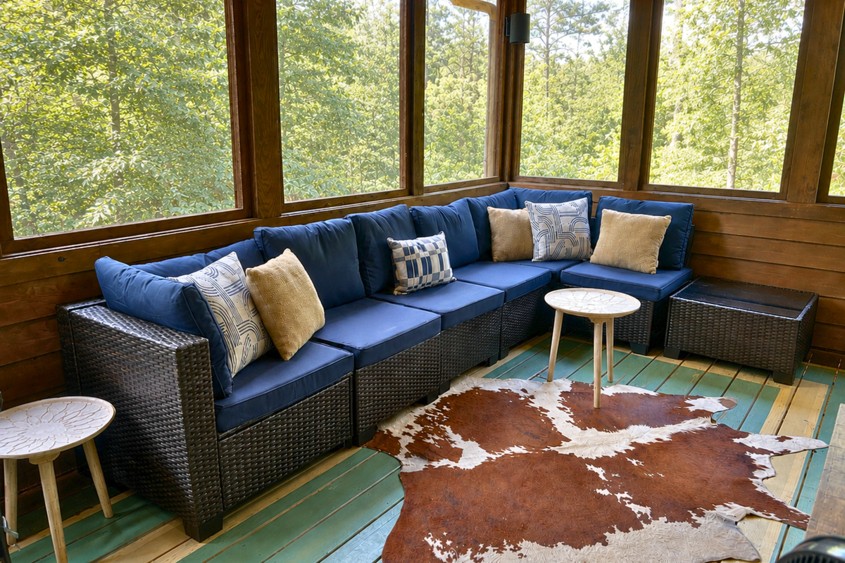 A cozy sectional creates a comfortable spot to stretch out on the porch, making it easy to enjoy the outdoors without giving up the comforts of a living room.