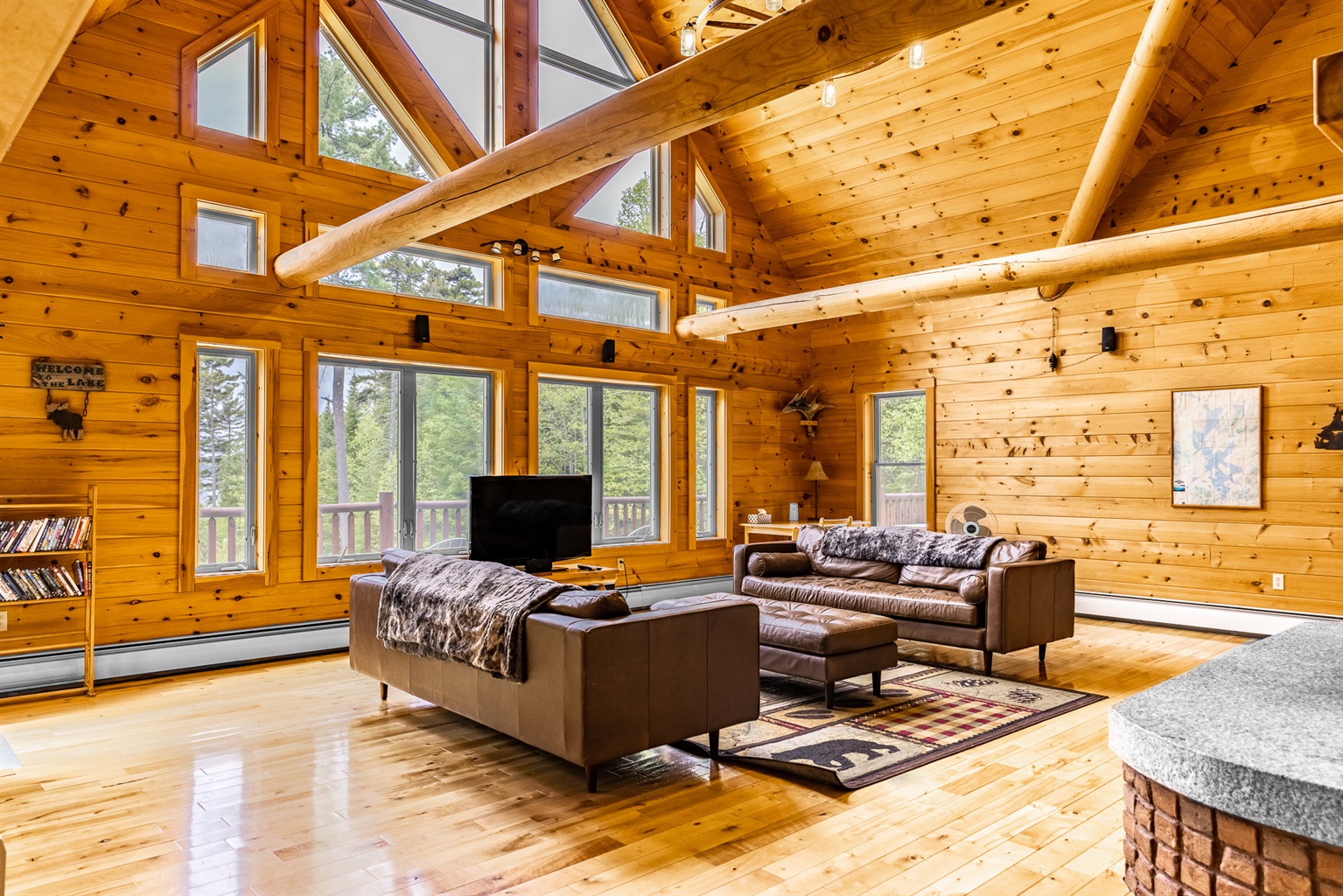 Chalet has huge logs and windows overlooking the lake giving it the true feel of lakefront retreat. Floor to ceiling wood-burning fireplace is impressive and great spot to enjoy the crackling sounds of fire while relaxing on comfortable leather couches.