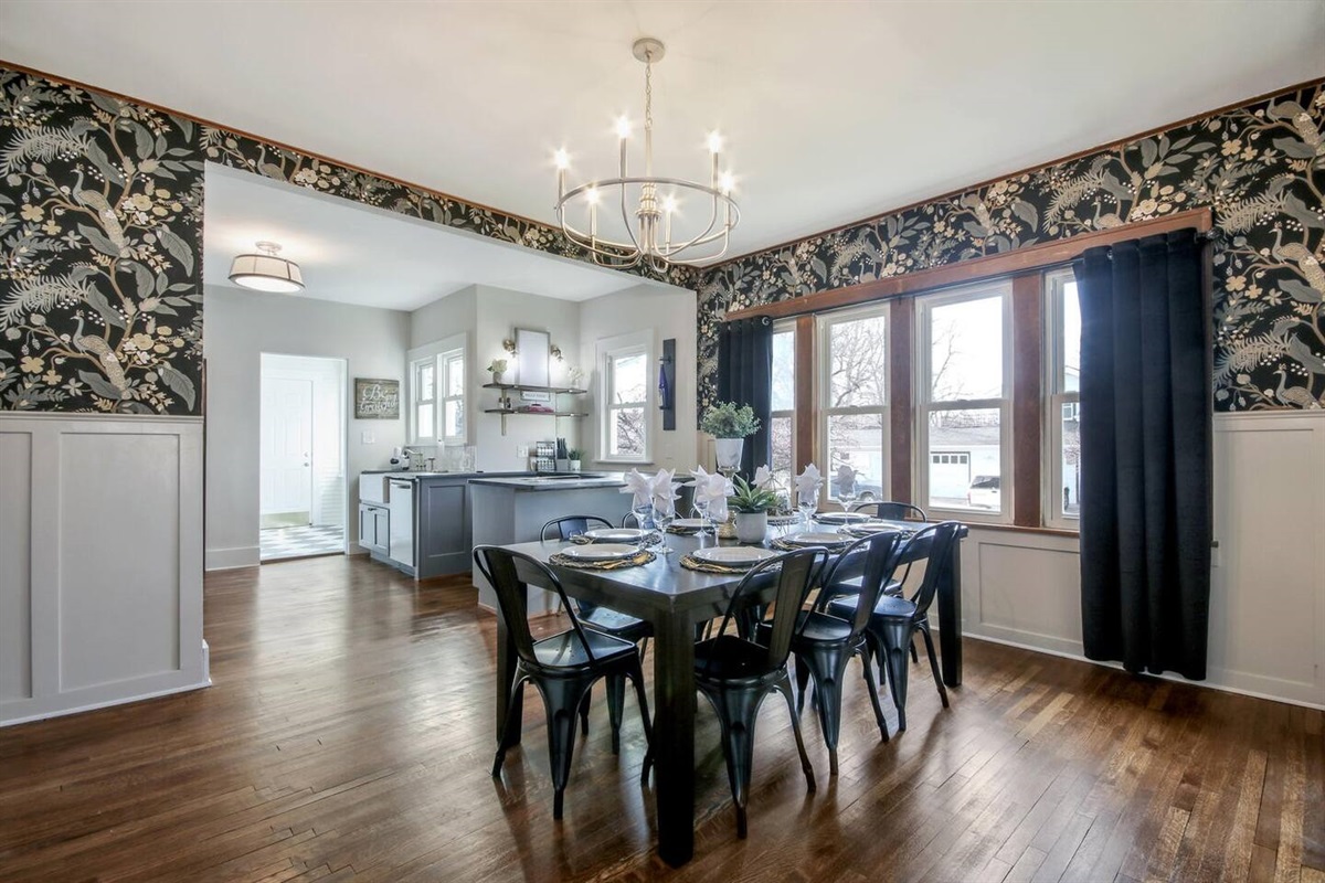 Dining room seats 8 at table, with two barstools at kitchen countertop.
