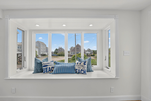 A bright window nook brings beach-inspired character and natural light into the home.