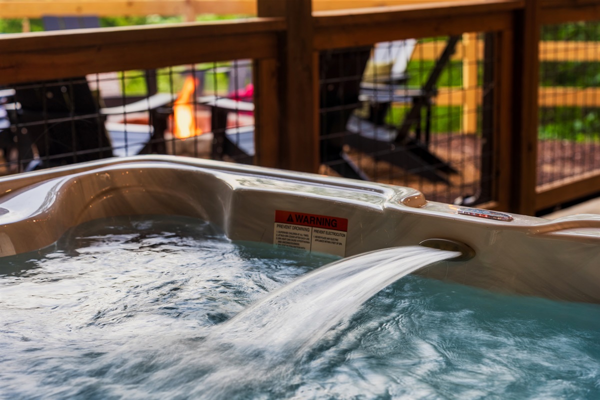 Soak in the hot tub with views of the backyard
